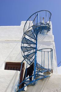 Spiral esternal staircase in a white house in naxos island, greece