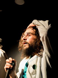 Close-up of holding mice while standing with hand in hair