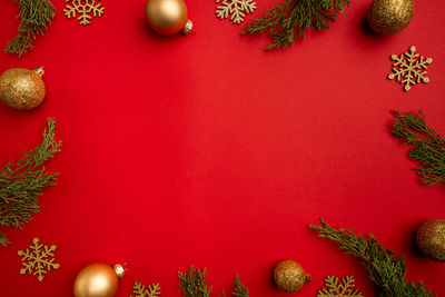 Directly above shot of christmas decorations on red background