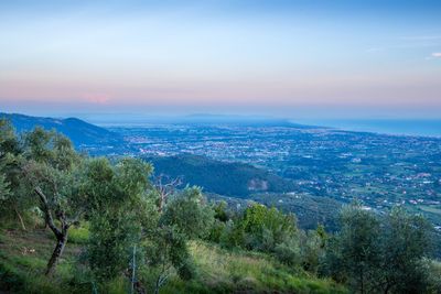 Scenic view of sea and mountains against sky