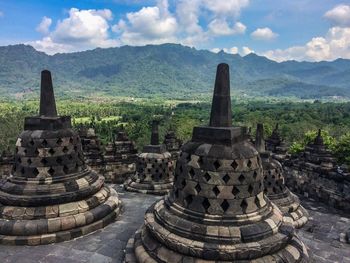 Ruins of temple against cloudy sky