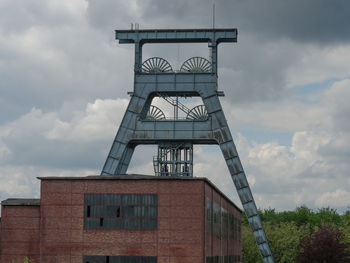 Low angle view of industrial building against sky