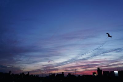 Low angle view of silhouette building against sky