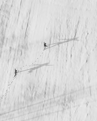 Aerial view of friends walking on snow covered field