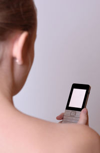 Close-up of cropped hand holding white background