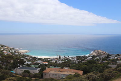 High angle view of townscape by sea against sky