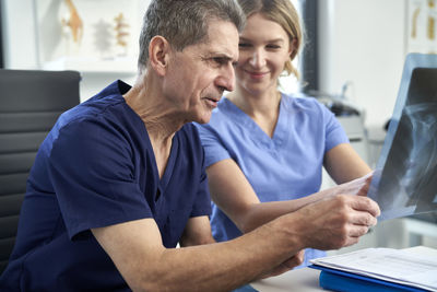 Healthcare workers examining x ray at clinic