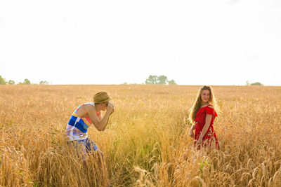 Women on field against sky