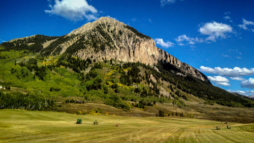 Scenic view of mountains against blue sky