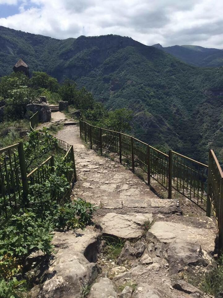 STEPS LEADING TOWARDS MOUNTAIN RANGE AGAINST SKY