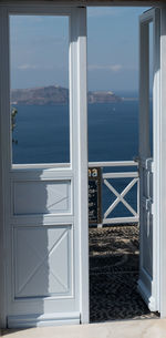 Close-up of sea against sky seen through window