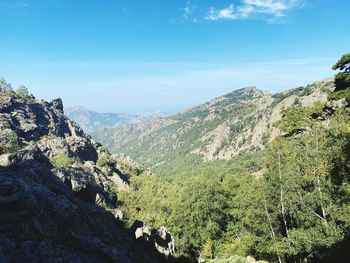 Scenic view of mountains against blue sky