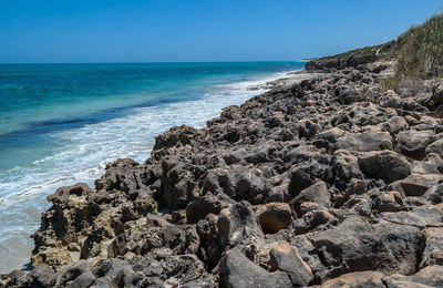 Scenic view of sea against clear blue sky