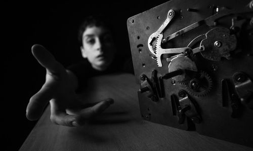 Close-up of man holding toy on table at home