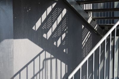 Shadow of railing on wall of building