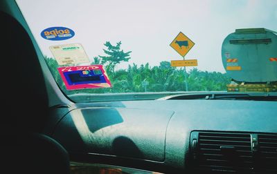 Close-up of car moving on road