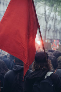 Rear view of woman holding umbrella