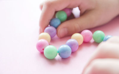 Close-up of hand holding multi colored candies