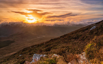 Scenic view of landscape against sky during sunset