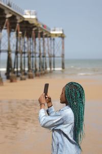 Woman photographing at beach