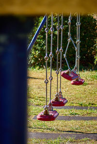 Close-up of swing hanging on grass