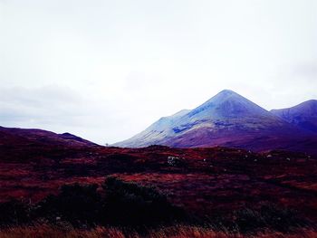 Scenic view of mountains against cloudy sky