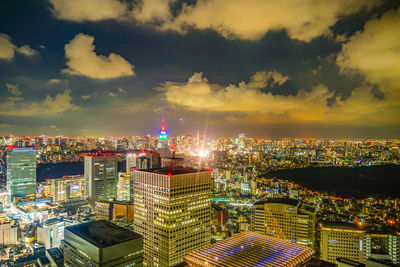 Illuminated cityscape against sky at night