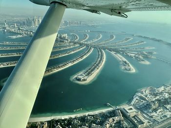 Palm jumeirah island dubai - high angle view of cityscape against sky