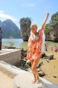 Portrait of happy woman standing at james bond island