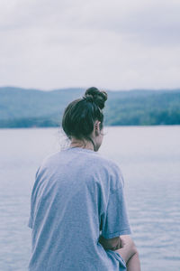 Rear view of woman looking at sea against sky