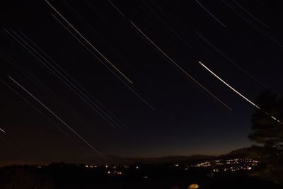 Low angle view of city against sky at night