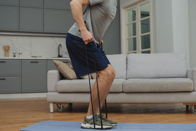 Low section of woman exercising in gym