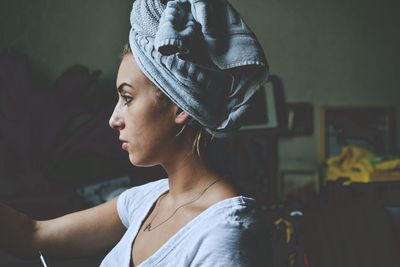 Close-up of woman with towel around her head