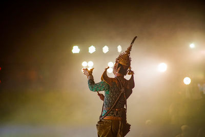 Low angle view of illuminated lighting equipment at night