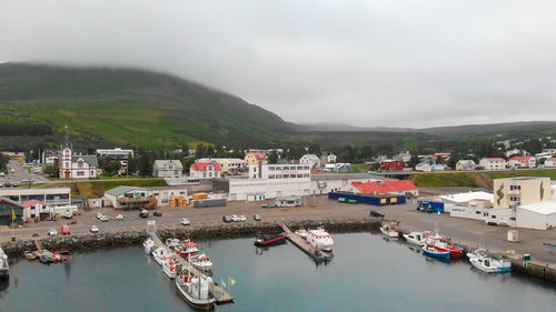 High angle view of boats moored at harbor in city