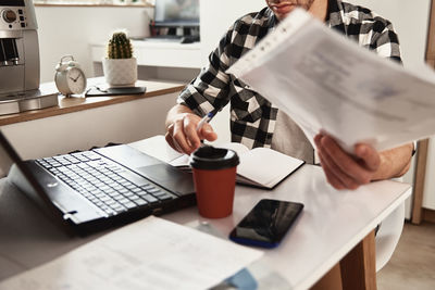 Man working at home office with laptop and smartphone. online business concept. remote work