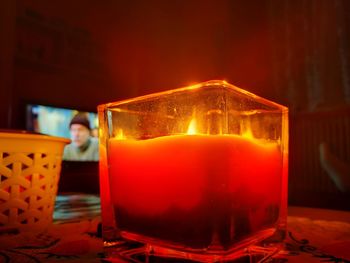 Close-up of illuminated tea light candle on table