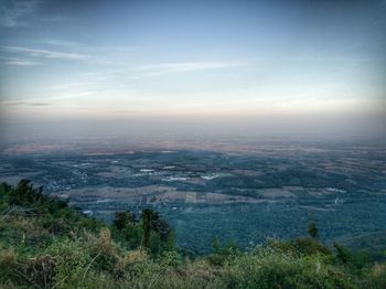 Scenic view of landscape against cloudy sky