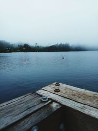 Pier over lake against sky