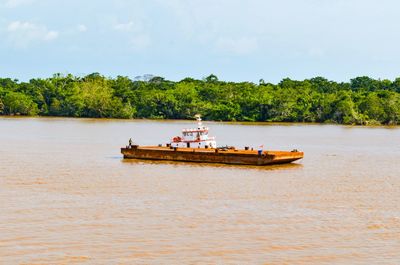 A barge cross over the kapuas river. pontianak, west borneo, indonesia