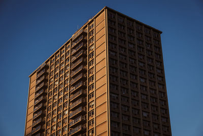 Low angle view of modern building against clear blue sky