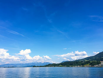 Scenic view of sea against blue sky