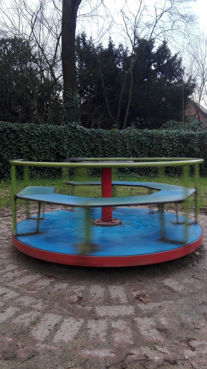 CLOSE-UP OF PLAYGROUND AGAINST TREES