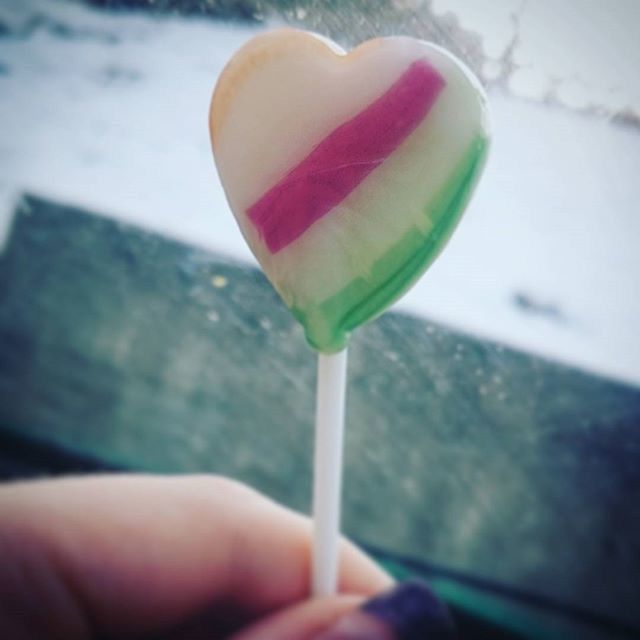 freshness, close-up, focus on foreground, holding, person, part of, cropped, pink color, food and drink, ice cream, sweet food, day, frozen food, flower, selective focus, red, outdoors, heart shape, indulgence, fragility