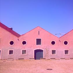 Low angle view of built structure against clear blue sky