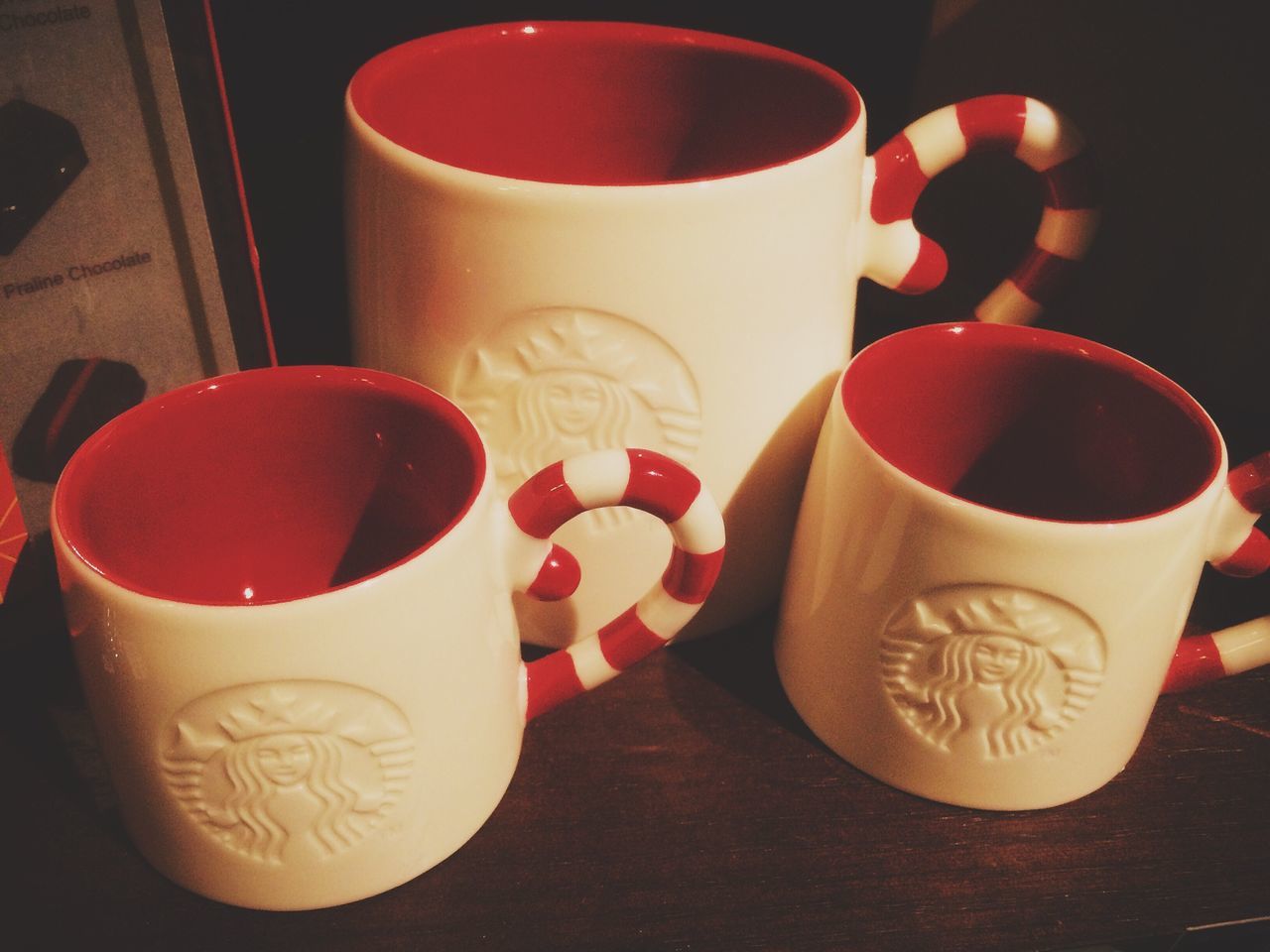 drink, food and drink, refreshment, coffee cup, indoors, table, coffee - drink, freshness, saucer, still life, cup, coffee, red, close-up, frothy drink, tea cup, high angle view, drinking glass, healthy eating, tea