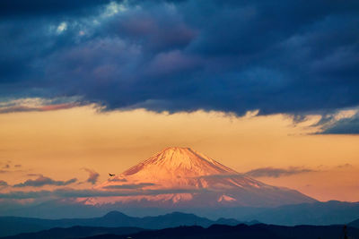 Scenic view of snowcapped mountains against sky during sunrise