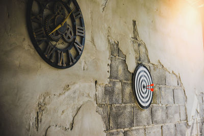 Low angle view of clock on wall