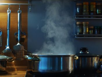 Close-up of steaming pot on stove in kitchen