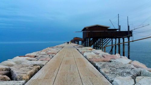 Pier over sea against sky